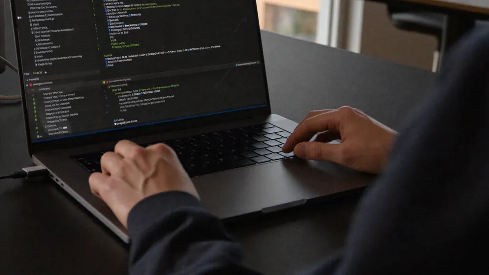 An engineer working at a laptop in a quiet office